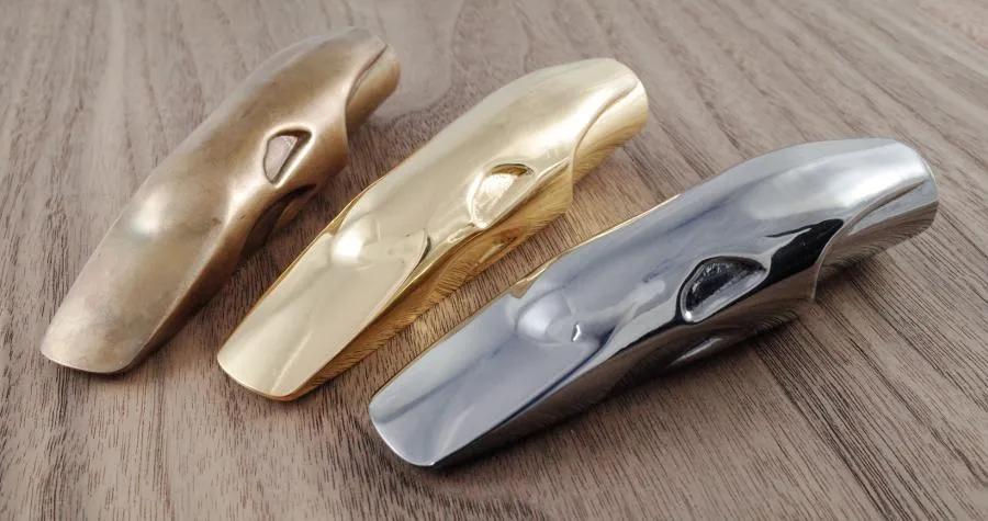 Three early Orca prototypes: raw bronze, 24 karat gold plating and black rhodium plating